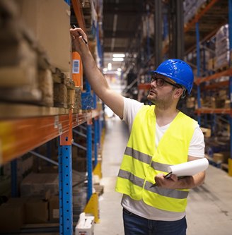 warehouse-worker-checking-inventory-large-distribution-warehouse.jpg